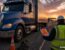 Roadside DOT inspection at dusk with an OUT OF SERVICE sticker on a semi-truck — commercial trucking out-of-service violation guide by Ensure Inc., Barrington IL insurance agency